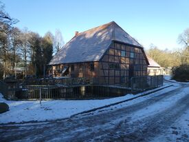 Wassermühle Kuchelmiß - Ansicht der Mühle mit Bücke und neuen Wehr 2025
